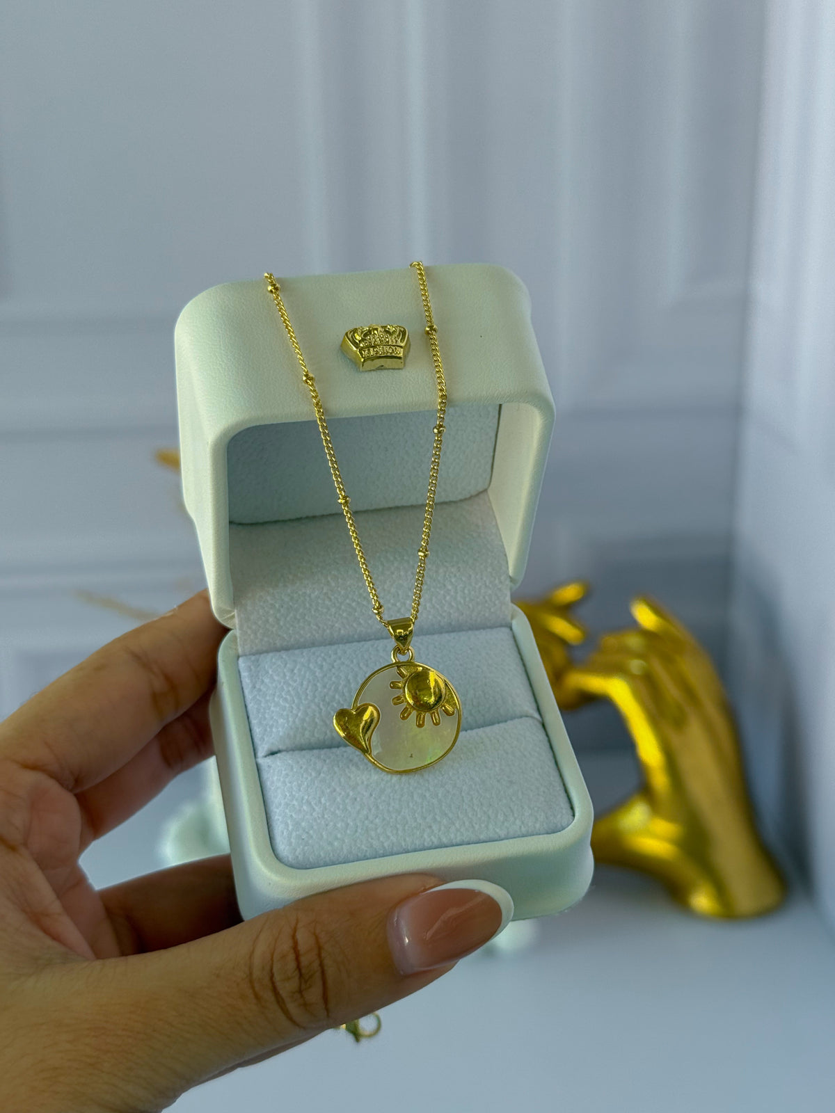 Mother-of-pearl chain with a sun charm