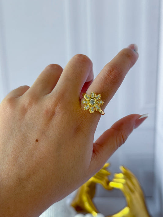Anillo giratorio de flor dorada