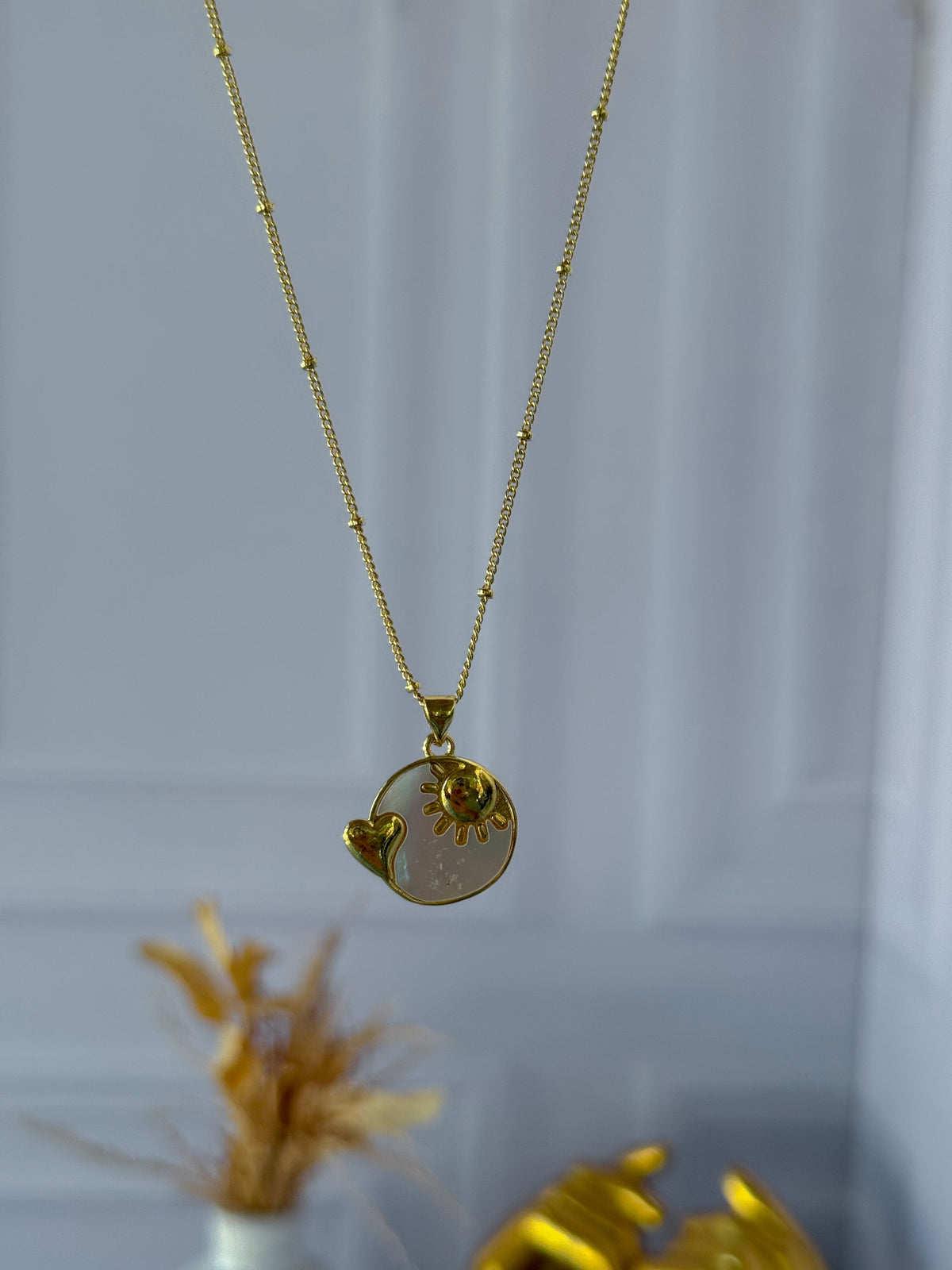 Mother-of-pearl chain with a sun charm